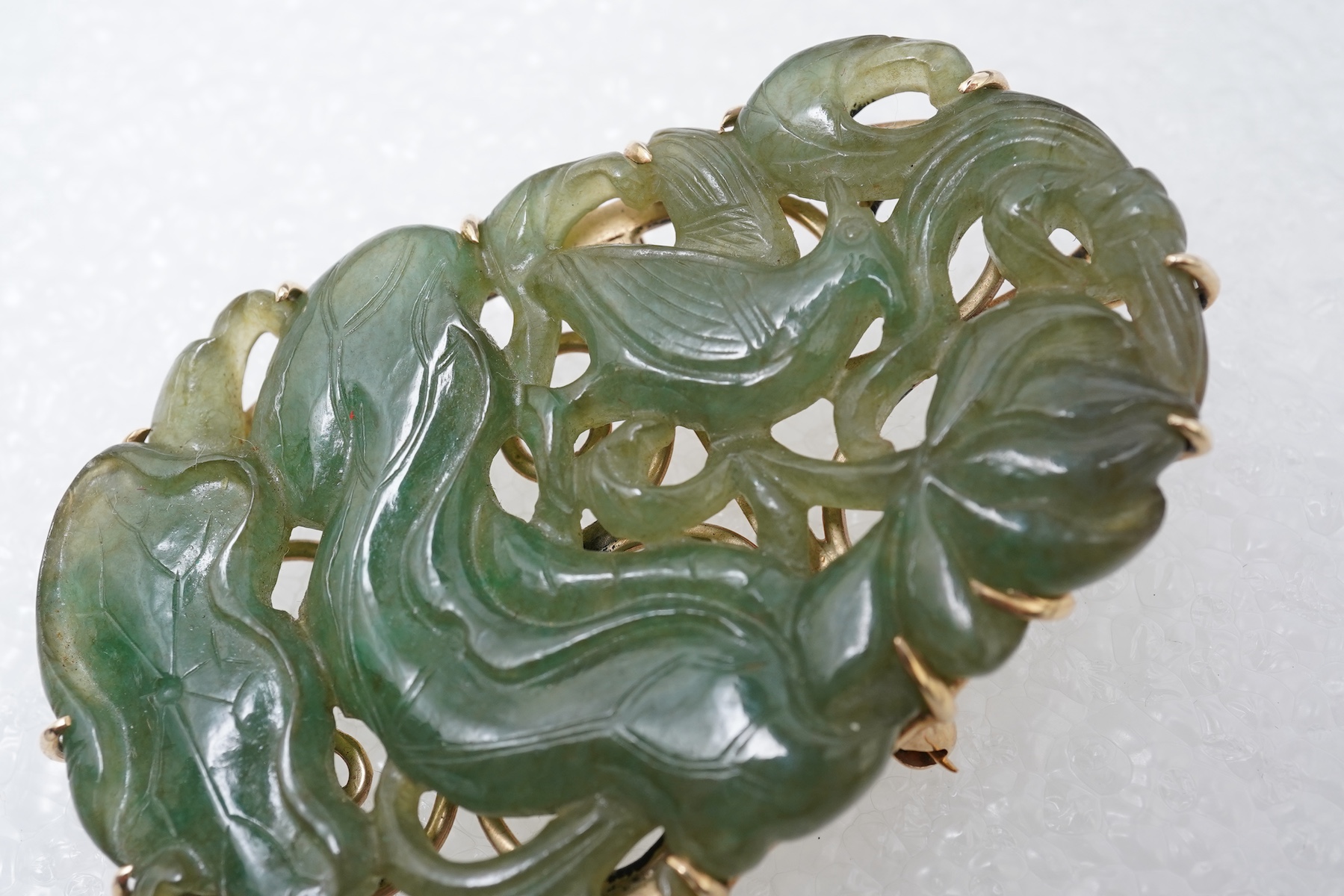 A carved jadeite brooch/pendant